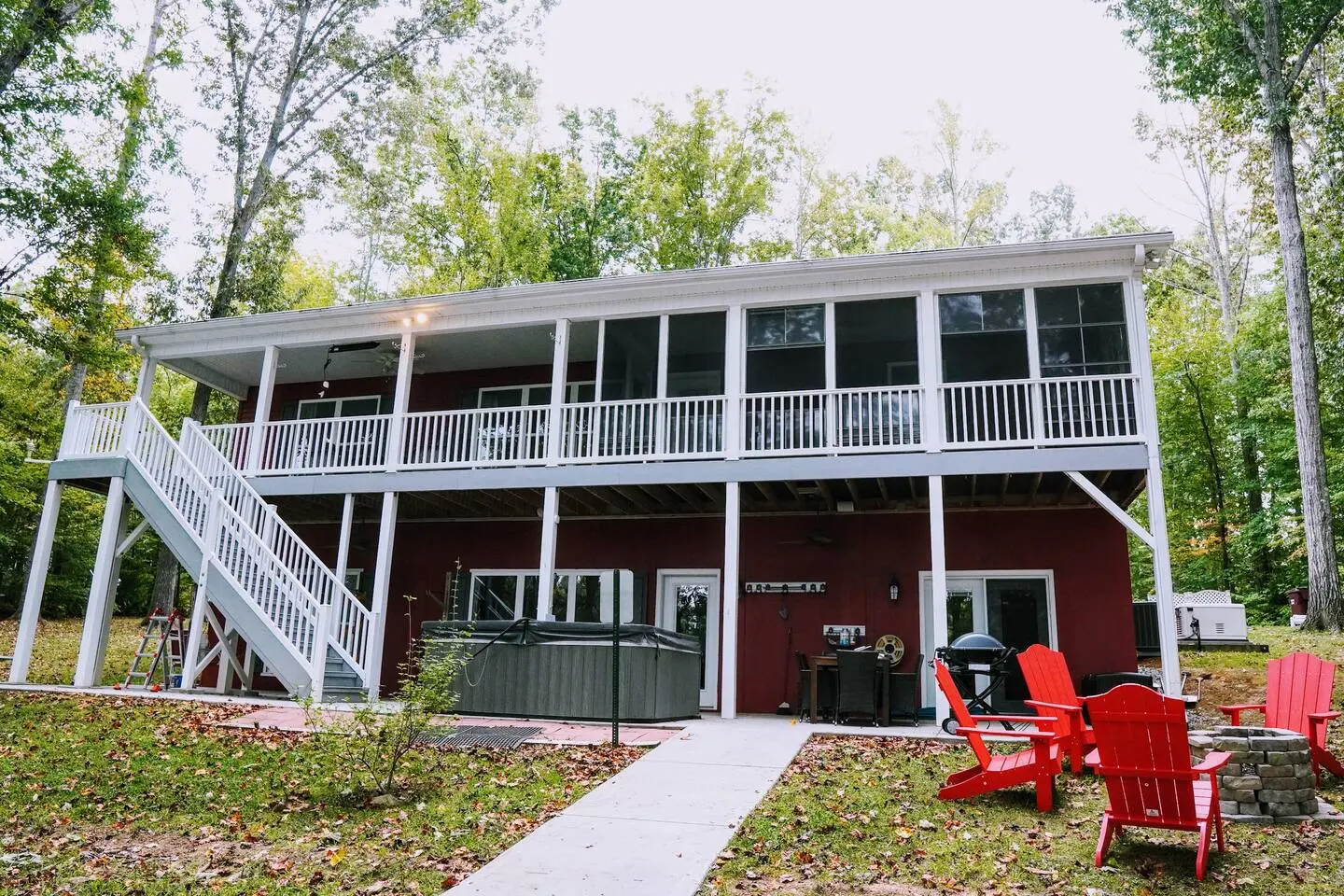 The lake house's stacked, multi-level decks seen from the sloping back lawn