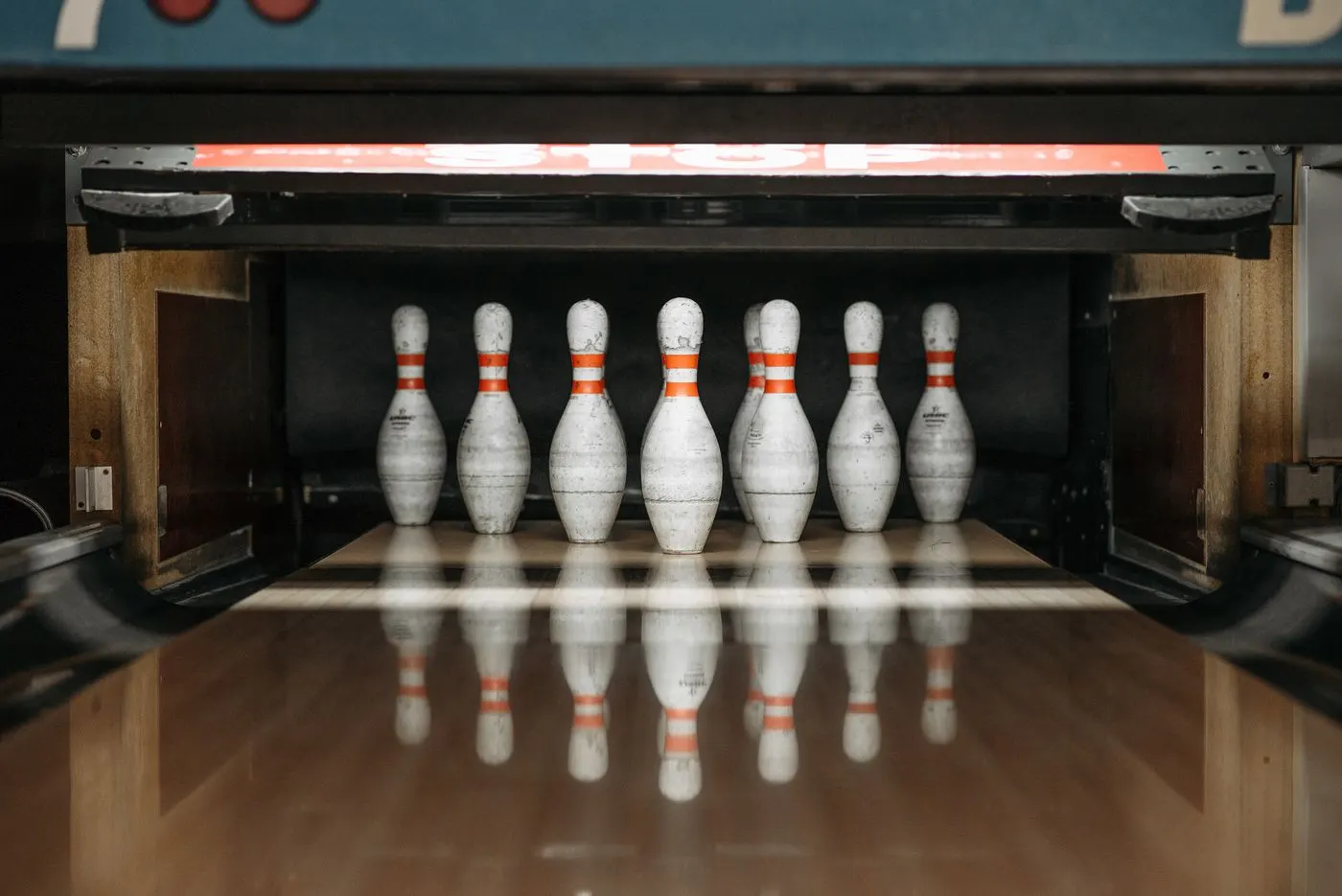 Bowling pins reflected at the end of a polished lane